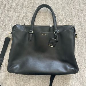 Lightly used tumi laptop bag. Will slide on luggage. Slim brief.